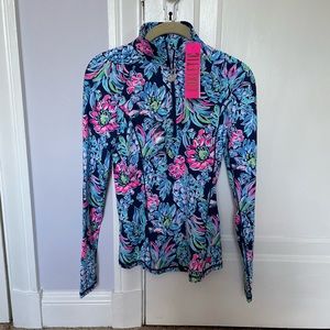 UPF 50+ Luxletic half-zip sunguard w shirt-tail hem, shirring on shoulders.